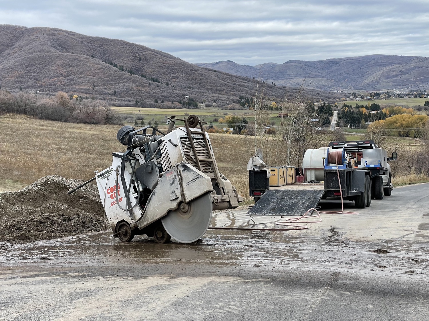 A walk behind concrete saw and water rig on a job across the Wasatch Front