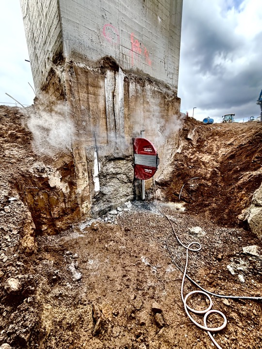 Wire sawing through the base of a concrete column in an excavation