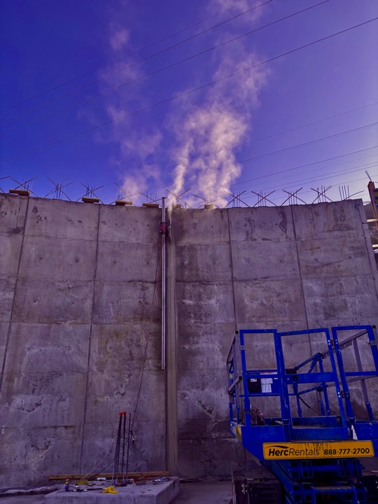 Wall and wire sawing a tall concrete wall from a lift